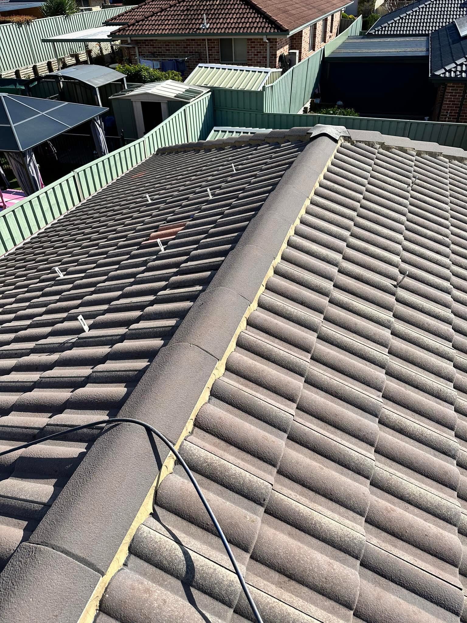 Ridge caps rebedded with weep holes — after