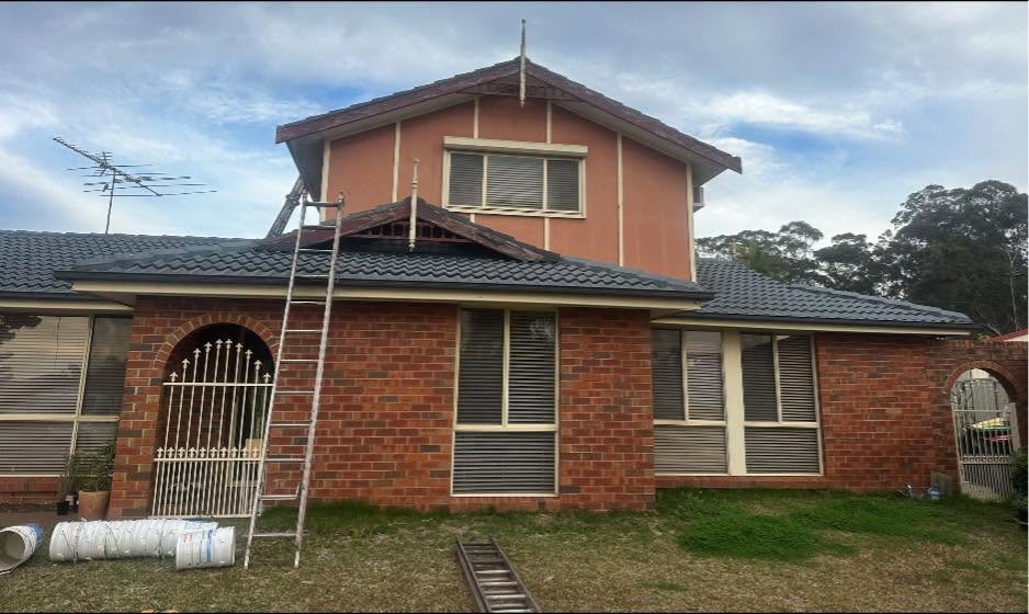 Example after — restored tiled roof with ladders on site