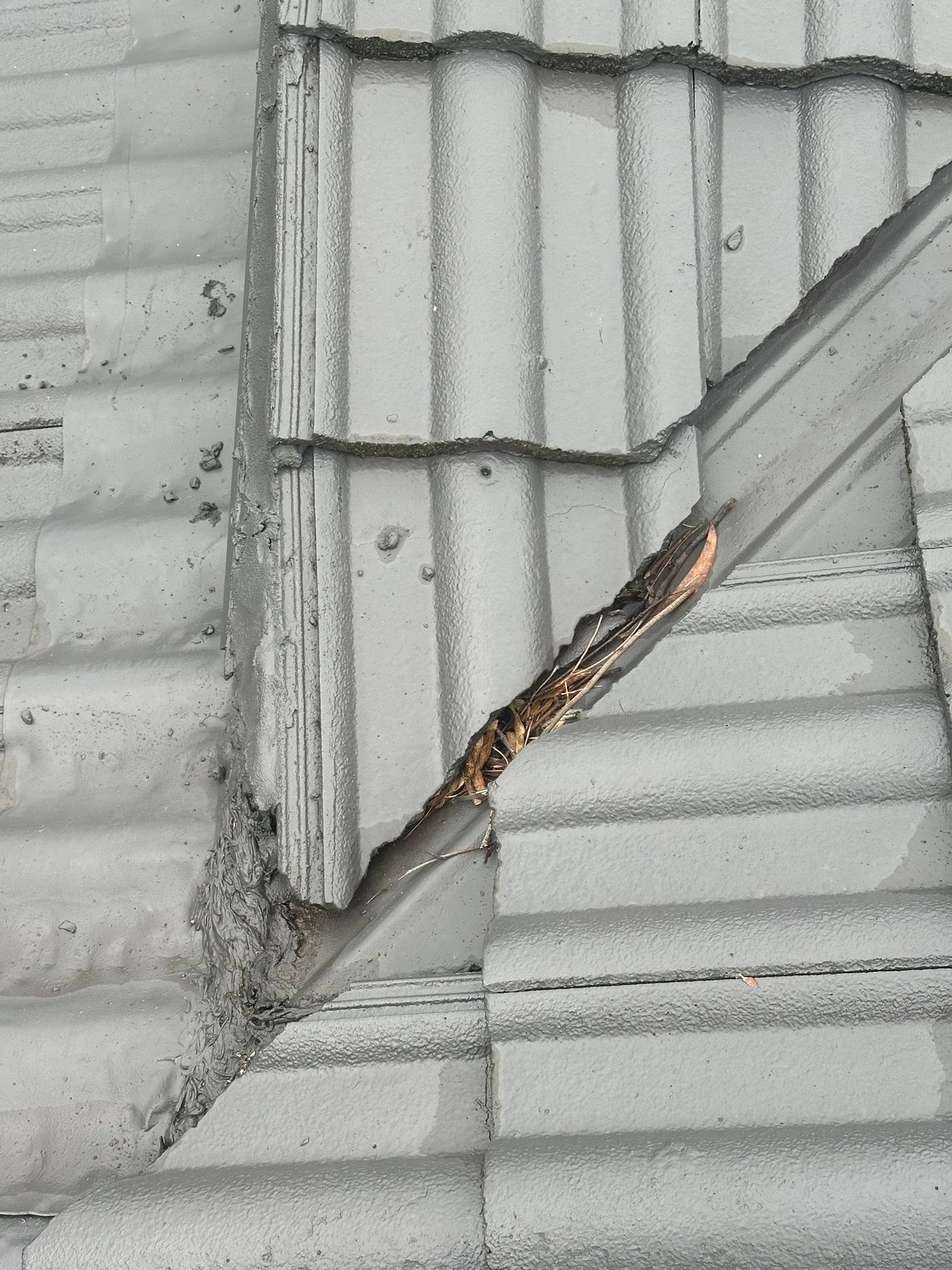 Broken and missing roof tiles before replacement