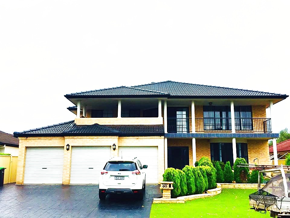 Finished charcoal tiled roof on a two-storey Western Sydney home — DNA Roof restoration