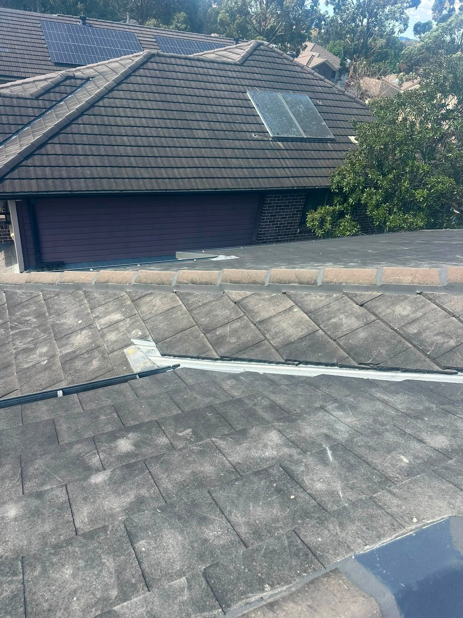 Western Sydney tile roof job — charcoal flat tiles and ridge work by DNA Roof